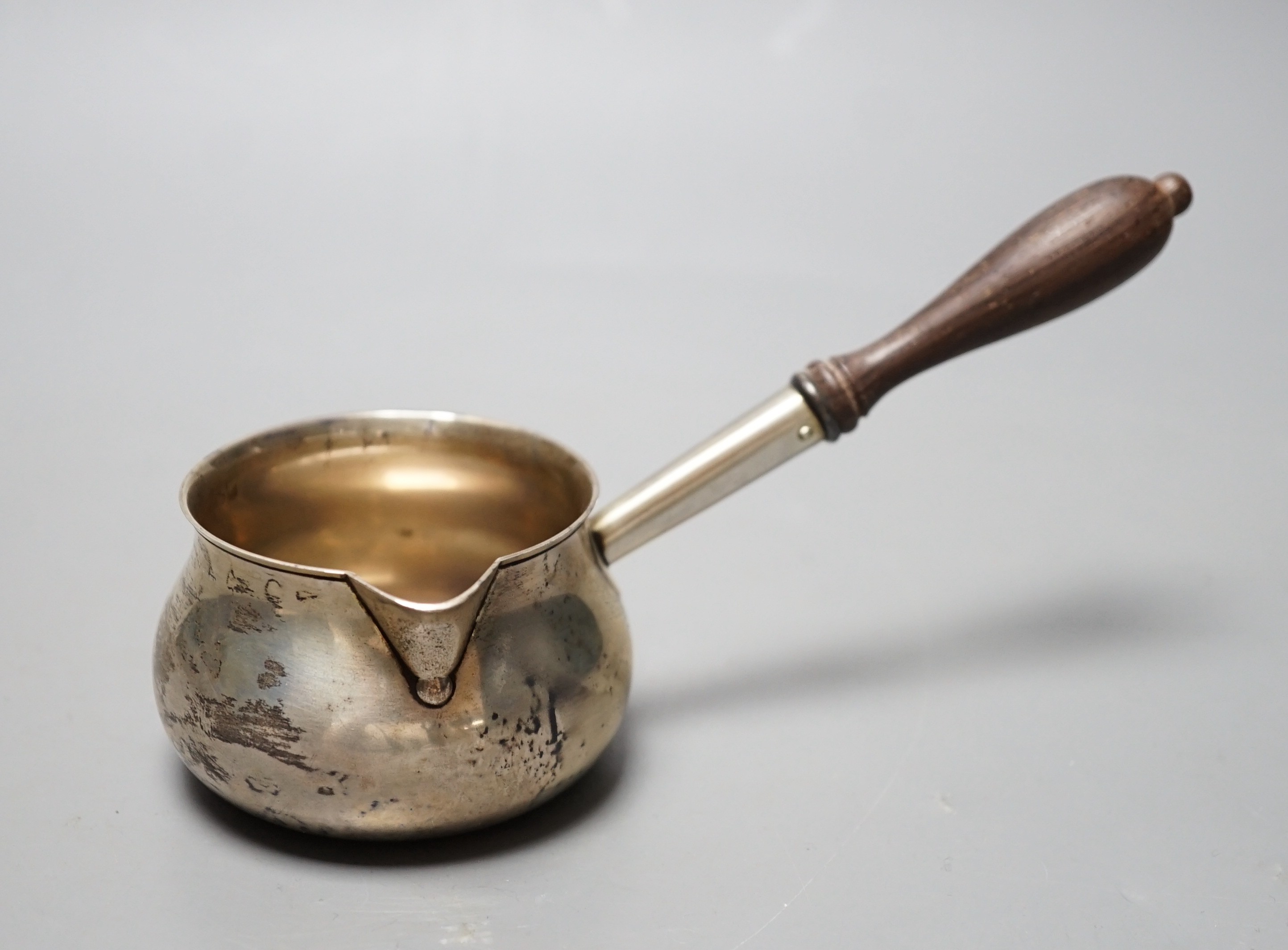 A modern silver brandy warmer, with turned wooden handle, Bryan Savage, London, 1973, 16.8cm, gross 81 grams, in an Asprey box.